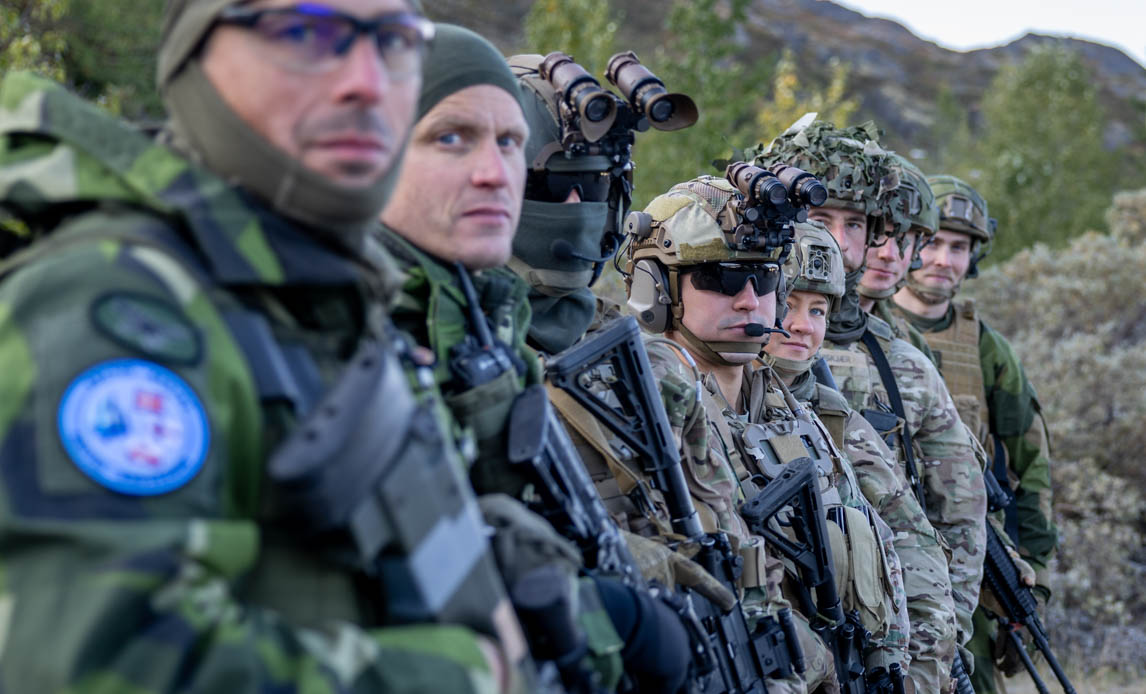 soldater står på række og kigger ind i kameraet